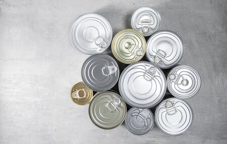 Group of tin cans on gray background. Top view or above