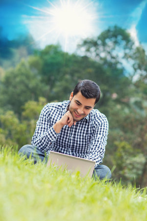 Happy young man with laptop, outdoor - outside