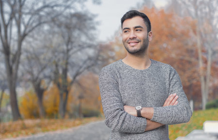 Young handsome man with crossed arms. Outdoor, outsideの写真素材