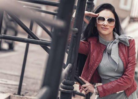 Beautiful girl posing, outdoors. Young expressive woman. Fashion photo.