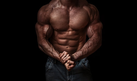Bodybuilder isolated on black background. Strong - hard muscleの写真素材
