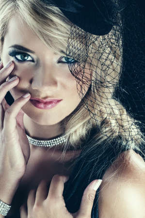 Portrait of beautiful blond woman, isolated on black background. Studio shot