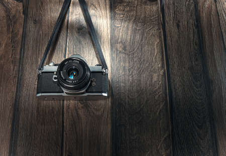 Old photo camera hanging wooden boards. Copyspace - space for text