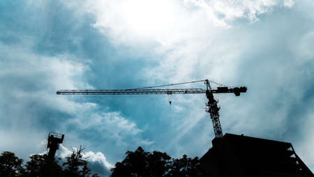 Silhouette building and crane, facility constructionの写真素材