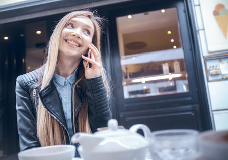 Happy women on smartphone in cafes, outsideの写真素材