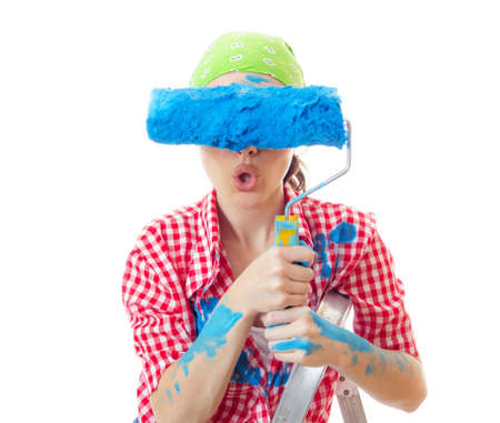Amazed woman painter holding roller over her eyes, ready for wall painting or new home renovating, isolated on white. Funny conceptの写真素材