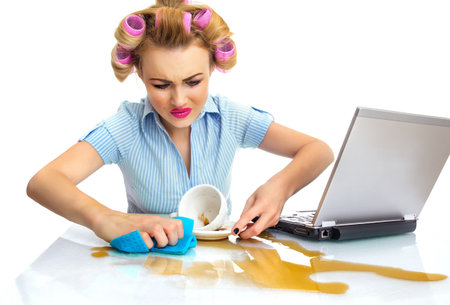 Funny business woman cleaning desktop. Dirty workspaceの写真素材