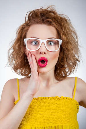 Surprised young funny woman, close-up portrait of a girlの写真素材