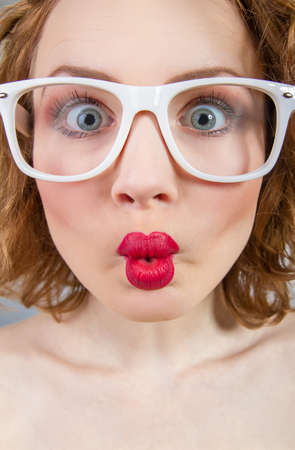 Close-up grimace of a funny woman with closed mouthの写真素材