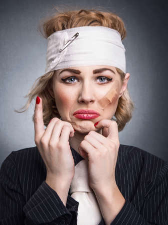 Funny woman with diaper head showing pain and cryingの写真素材