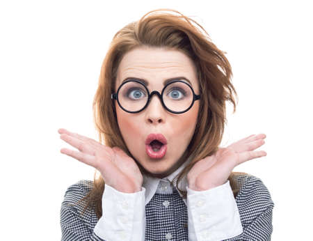Amazed young geek or loony woman isolated on white background. Surprised girl, close-up face wearing funny eyeglassesの写真素材