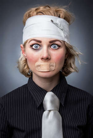 Portrait of an injured woman with adhesive bandage over muothの写真素材