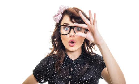 Amazedly woman showing with her fingers something small, isolated on whiteの写真素材