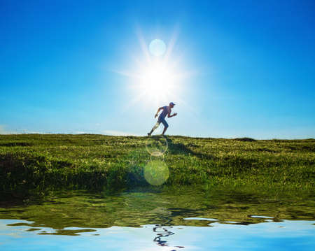 Activity - vitality man running on field - grass. Healthy lifestyleの写真素材