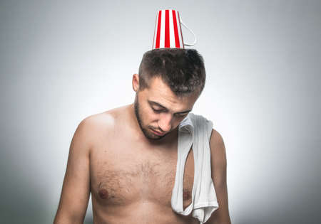 Funny drowsy man with undershirt on his shoulder, undressed guyの写真素材