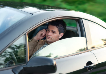 Successful businessman driving car and call. Young gorgeous guy