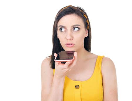 Close up young woman on the phone isolated on white background. Girl using the mobile phone. Studio shotの写真素材