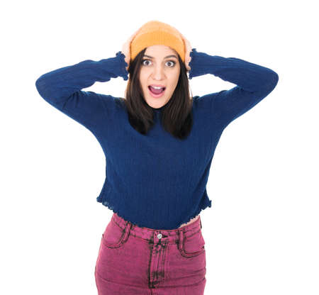 Surprised young woman with hands on his head, isolated on white background. Positive news. Astonished pretty girl. Studio shotの写真素材