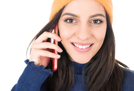 Close up happy young woman talks on the phone, isolated on white background. Female using the smartphone. Studio shotの写真素材