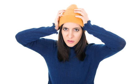 Mistake. Worried young woman holding her arms on head, isolated on white background. Studio shotの写真素材