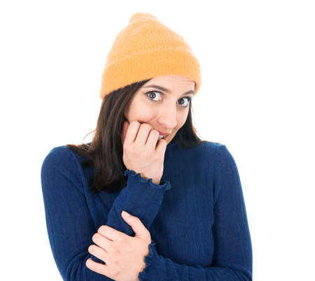 Scared young woman biting fingernail, being terrible accident, isolated on white background. Frightened girl. Studio shotの写真素材
