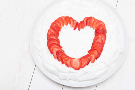 heart from strawberry whipped cream on a plateの写真素材