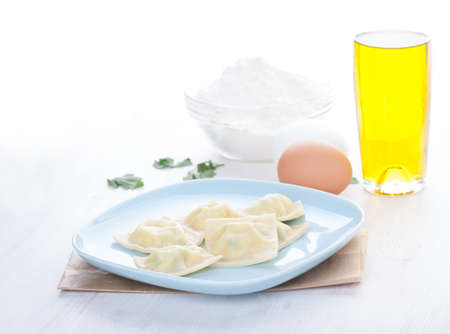 Homemade ravioli on a blue plateの写真素材