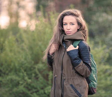 Beautiful Girl Long Hair. Tourist jacket, Backpack.
