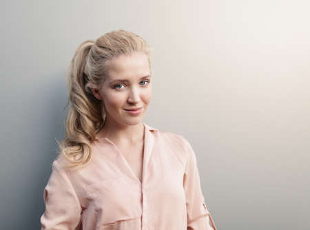 Portrait of young beautiful woman with long hair have fun and good mood looking in camera and smilingの写真素材