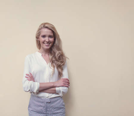 Portrait of young beautiful woman with long hair have fun and good mood looking in camera and smilingの写真素材