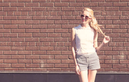 Outdoor summer sensual fashion portrait beautiful young blond womanの写真素材