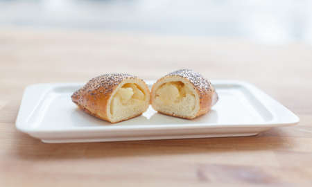 beautiful delicious cake with cream filling on a plate. Cut in half.の写真素材