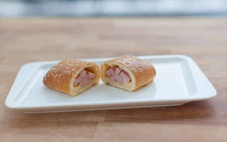 Beautiful delicious cake with ham and cheese filling on a plate. Cut in half.の写真素材