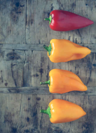 Fruits pepper red and yellow lie flat on a vintage kitchen board. background. top view. close-up.の写真素材