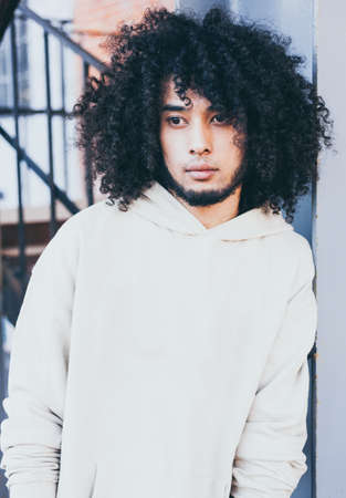 Close up portrait young fashionably dressed man in a cool outfit posing on the street. Young fashion, Streetstyle.の写真素材