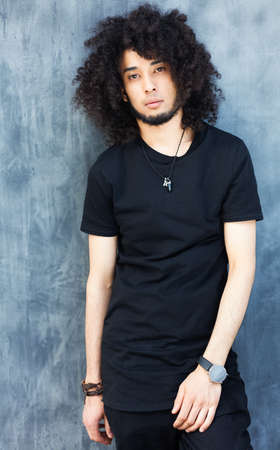 Fashionably dressed man in a cool black outfit posing on the street. Young fashion, Streetstyle....