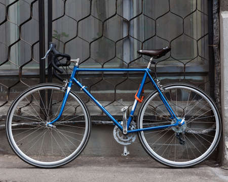 Bright blue Fixed Gear beautiful vintage bicycle stands on the street. Hipster.の写真素材