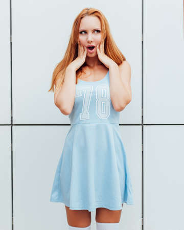 Outdoor fashion portrait of stylish young woman having fun, emotional face , laughing. Urban city street style. Spring or fall outfit. Summertime. Outdoor.の写真素材
