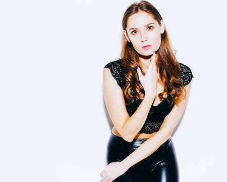 Portrait of beautiful brunette girl on white studio background. Indoor.の写真素材