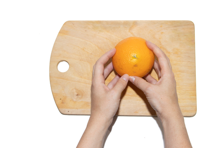 A cutting of an orange on a whiteboard is isolated on a white background. Fruits on the board. Fruits on a white background. Cutting fruit.の写真素材