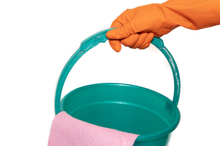 A bucket on a white background. The glove hangs on a plastic bucket. Plastic blue and green bucket on a white background. Bucket for washing floors.の写真素材