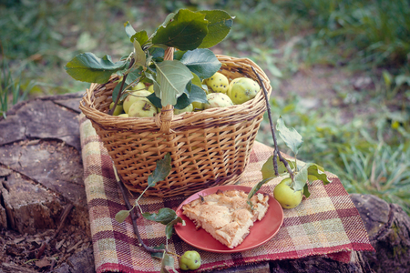 Basket with apples and charlotte from apples. Autumn harvesting. Collected homemade apples in the basket. Healthy foodの写真素材