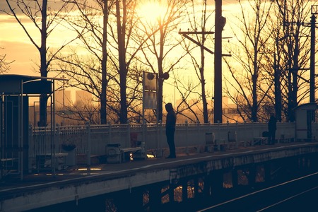 The Russian railway at sunset in the spring. Travel by transport. Transportation of passengers. Rails and sleepersの写真素材