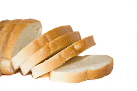 Baton in sliced on a white background. Baking from flour. White bread.の写真素材