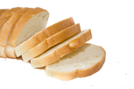 Baton in sliced on a white background. Baking from flour. White bread.の写真素材