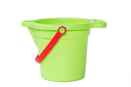 A child's green sand bucket is isolated on white background. Children's games. Hobbies and Recreationの写真素材
