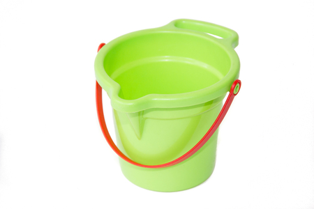 A child's green sand bucket is isolated on white background. Children's games. Hobbies and Recreationの写真素材
