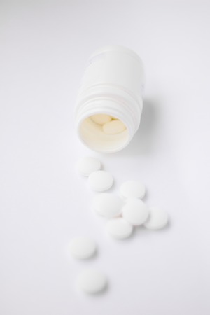 White pills on a white background. A cure for pain. Health and medicine. Chemical elements.の写真素材