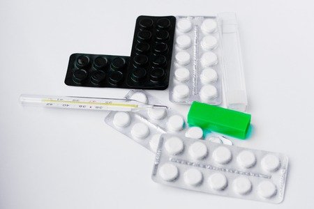 pills on white background. A cure for pain. Health and medicine. Chemical elements.の写真素材