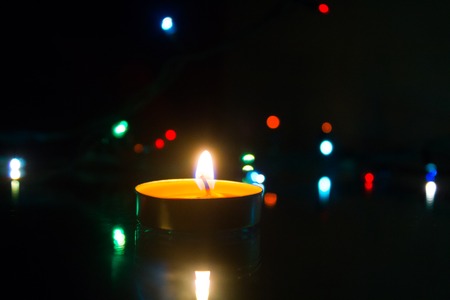 Wax candles burn in dark light. Wax candle. Burning fire Light from the fireの写真素材